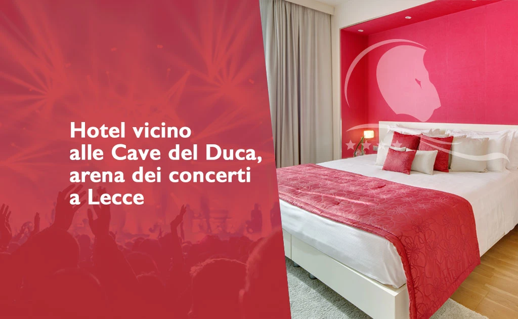 Promotional image featuring a hotel room with white walls and a red accent wall. The double bed is covered in white linens and a red bedspread, complemented by red and white pillows. The hotel logo is superimposed. On the left side of the image, against a red background with silhouettes of an audience and concert lights, is the text: "Hotel near the Cave del Duca, concert arena in Lecce." The room is bright, with light-colored curtains and a light-colored wood floor.